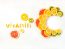 Vitamin C letters made of citrus fruits - lemon, grapefruit, orange and kiwi slices on white background